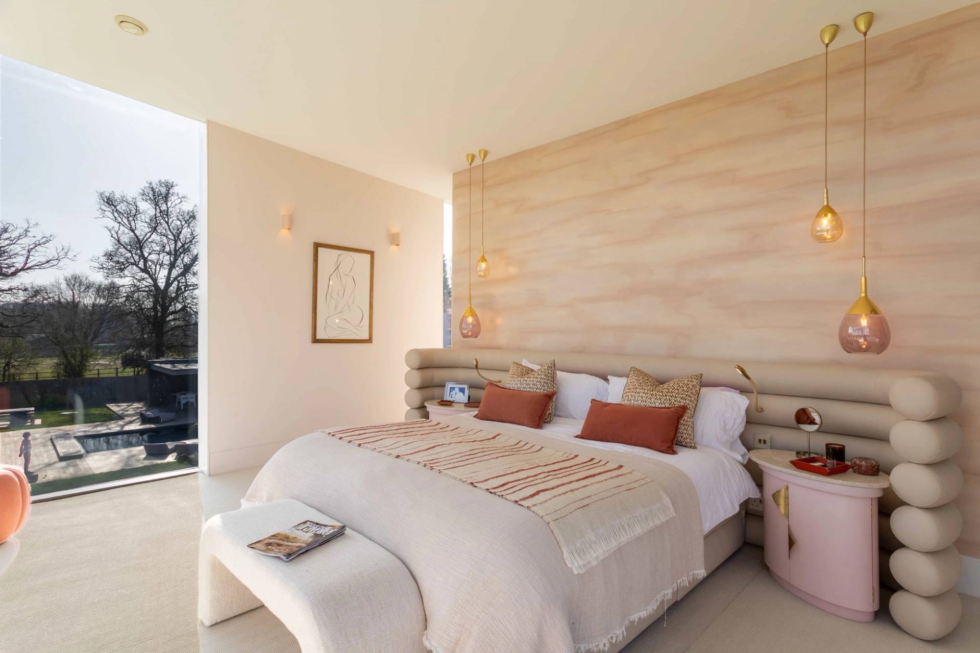 Love Locations boutique master bedroom Godalming Surrey: High-end bedroom featuring a light wood panelled feature wall and matching ribbed headboard, optimized for bedding and linen campaigns.