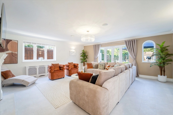 Formal reception room with plush beige sofas, velvet armchairs, and floor-to-ceiling drapes, Love Locations RM11.