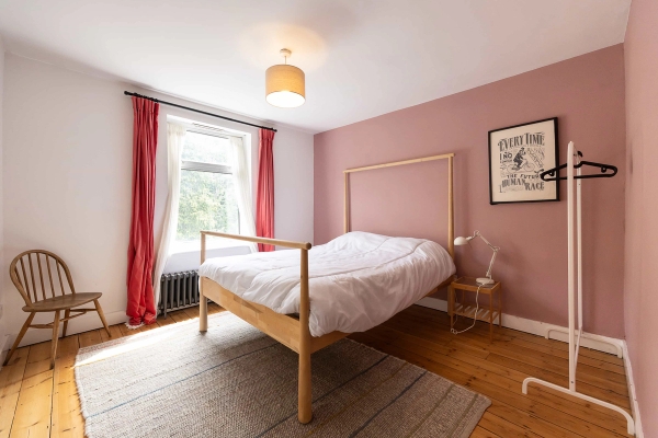 Love Locations dusty pink bedroom shoot space Forest Gate E7: Warm bedroom styled with a natural timber bedframe, soft terracotta-pink walls, and matching drapes, ideal for bedding campaigns.