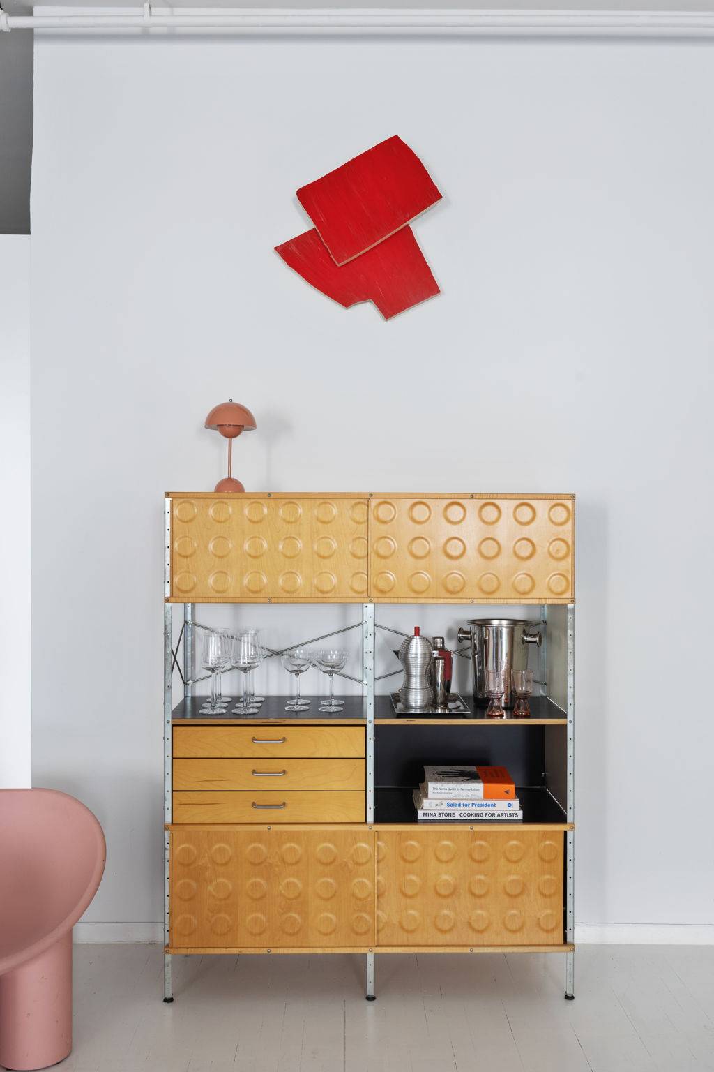 Mid-century modern credenza and red relief wall sculpture shoot venue in a white Tribeca loft curated by Love Locations.