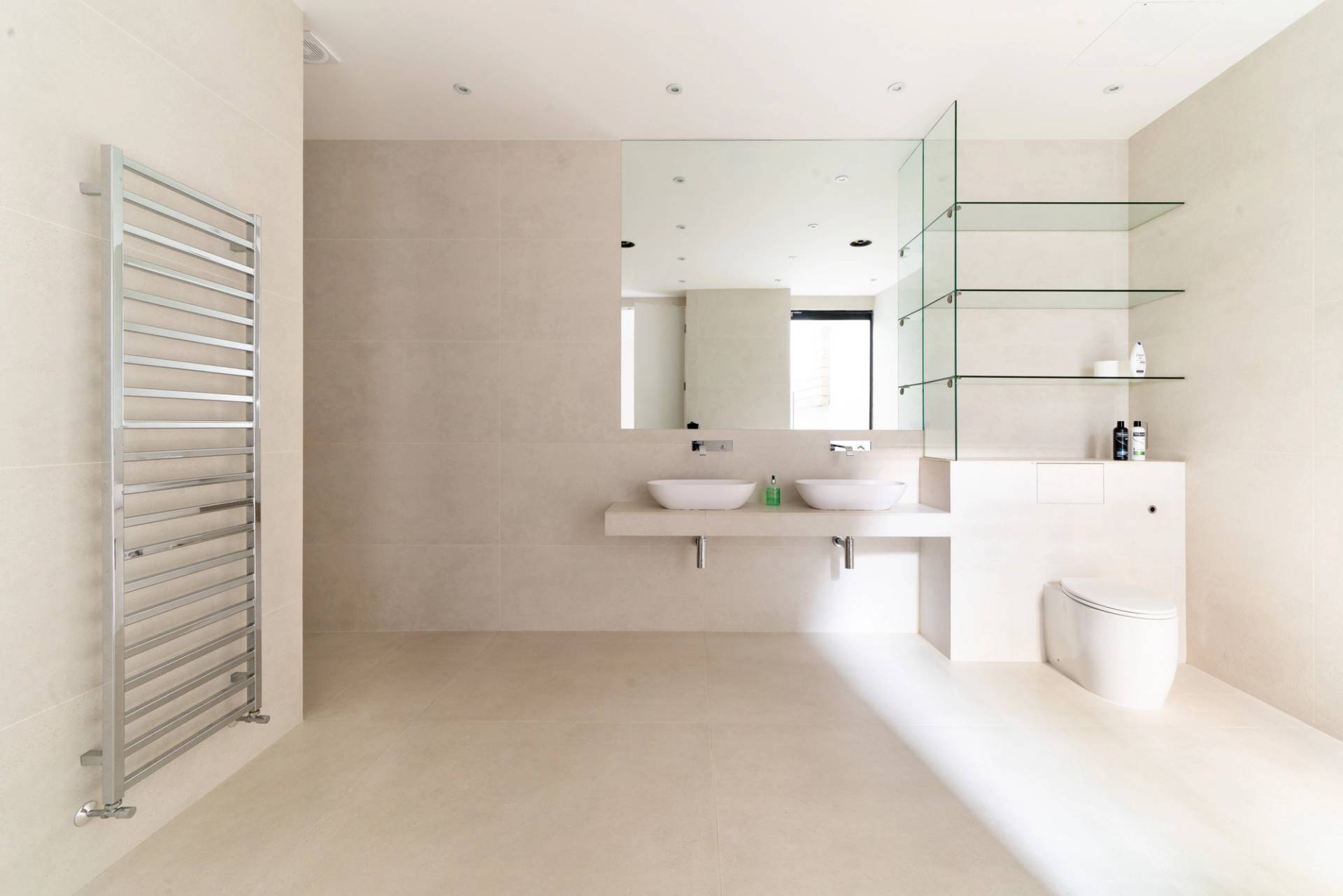 Spacious bathroom location featuring double sinks, floating vanity, and wall-mounted mirrors, Love Locations SW6.