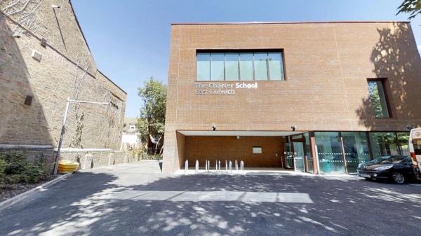 Contemporary red brick secondary school entrance facade and modern architecture in East Dulwich, bookable via Love Locations.
