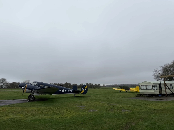 Airfield tarmac and runway background featuring vintage airplanes, ideal for aviation documentaries and military advertisement shoots, Love Locations NN17.