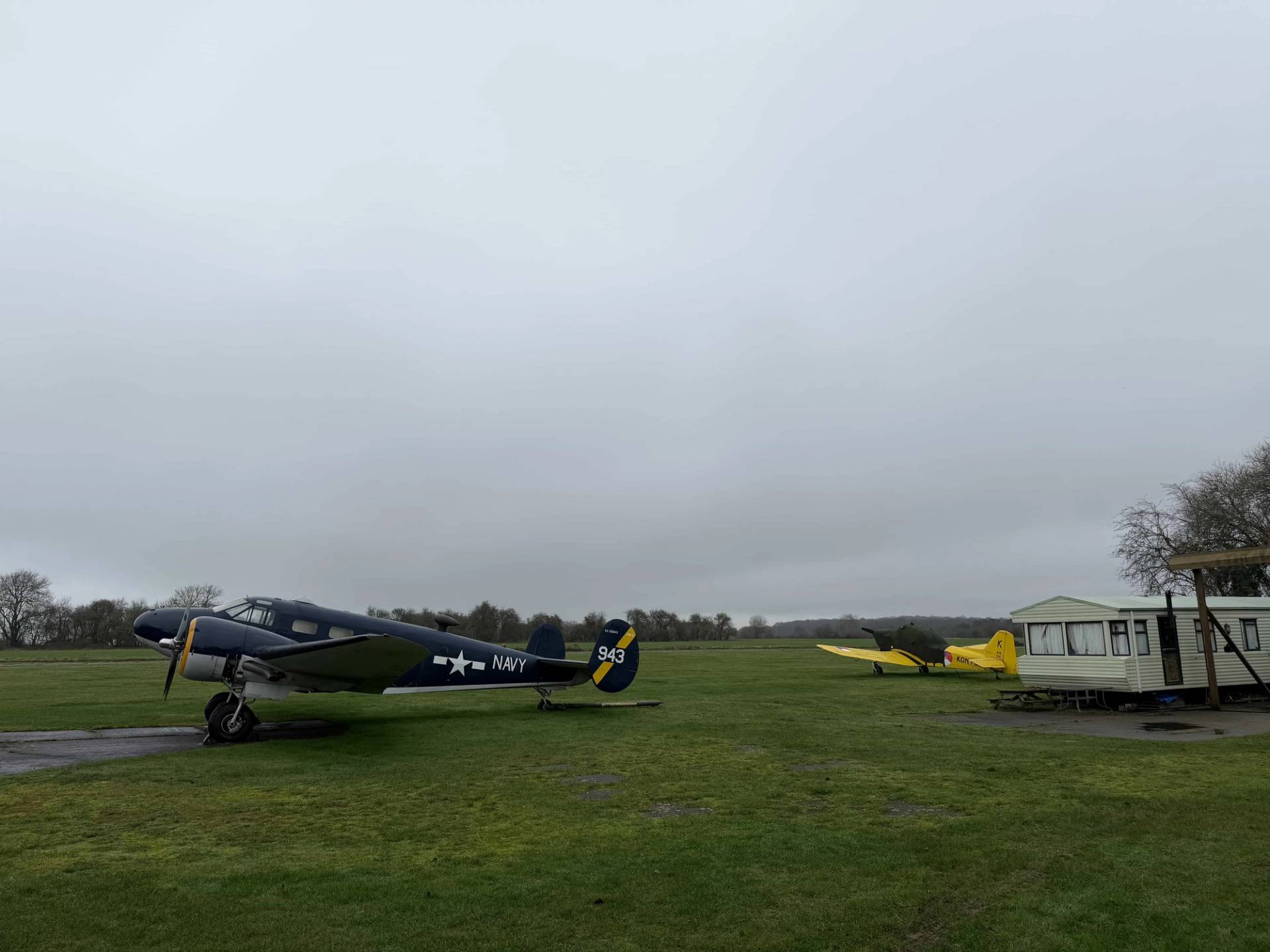 Airfield tarmac and runway background featuring vintage airplanes, ideal for aviation documentaries and military advertisement shoots, Love Locations NN17.