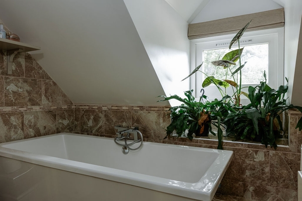 Freestanding bath beneath vaulted ceiling at Love Locations filming location in Liss, Hampshire GU33..