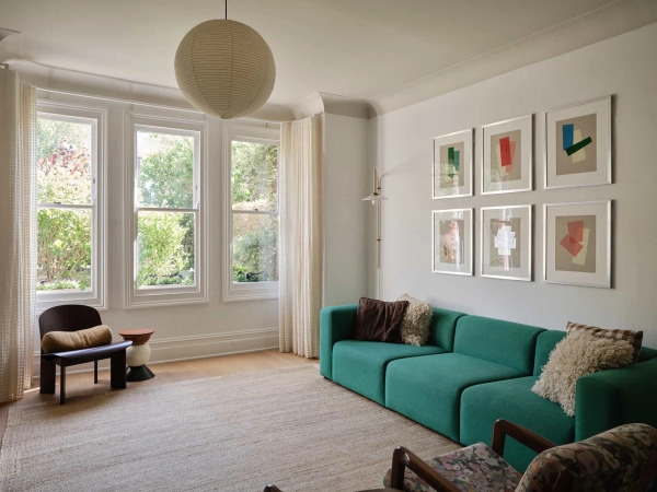 Love Locations elegant double reception room SE23: Airy family lounge showing a statement green sofa, high ceilings, and traditional Victorian sash window bays, ideal for TV series filming.