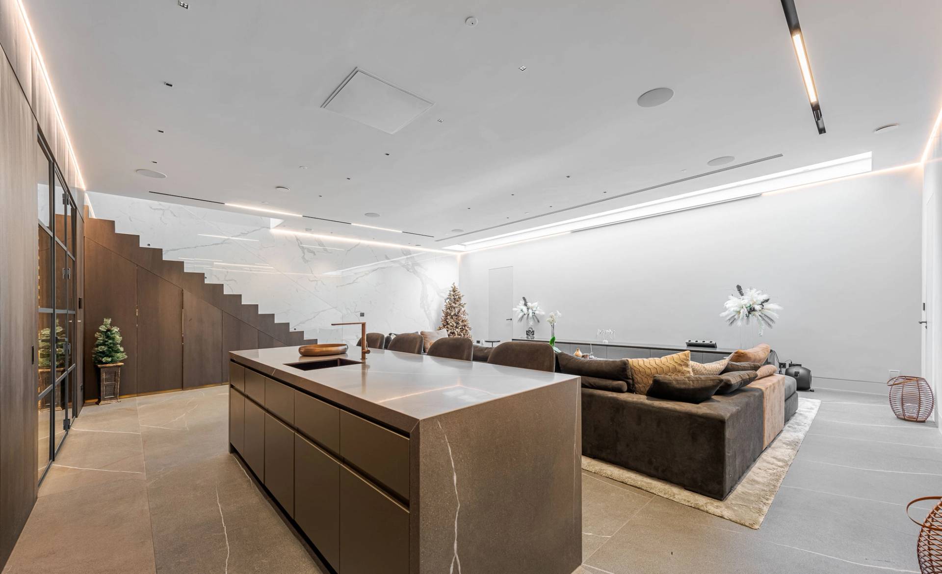 Subterranean cocktail lounge with dark marble kitchen counter, low sectional seating, and ambient lights, Love Locations SW11.