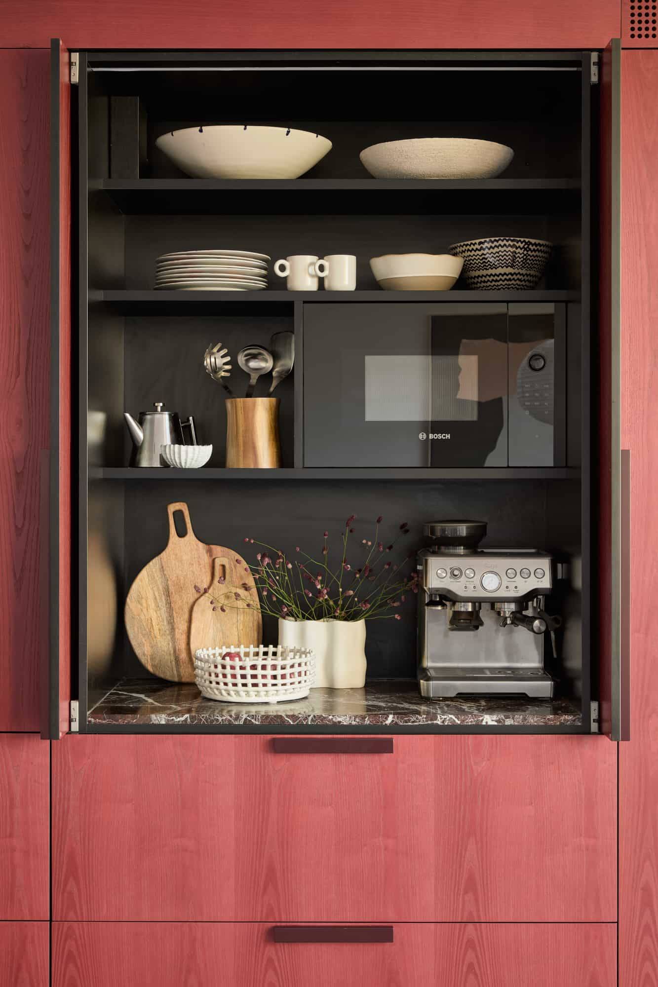 Love Locations high-end kitchen feature Lewisham SE23: Open breakfast larder cabinet with a built-in espresso machine, microwave, and wooden boards, ideal for domestic TV commercial sets.