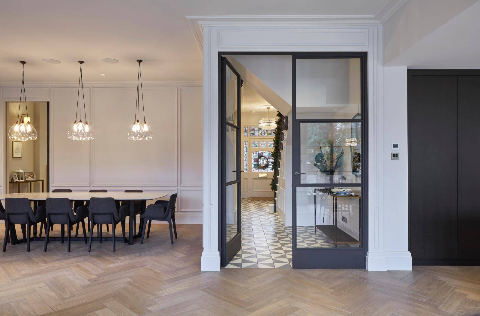 Glass Crittall door entrance leading into a grand reception hallway with geometric floor tiles, Love Locations TW11.
