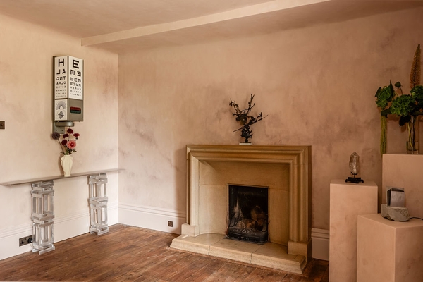 Bare stone fireplace hearth inside an empty, light-filled creative studio space available for set building through Love Locations.