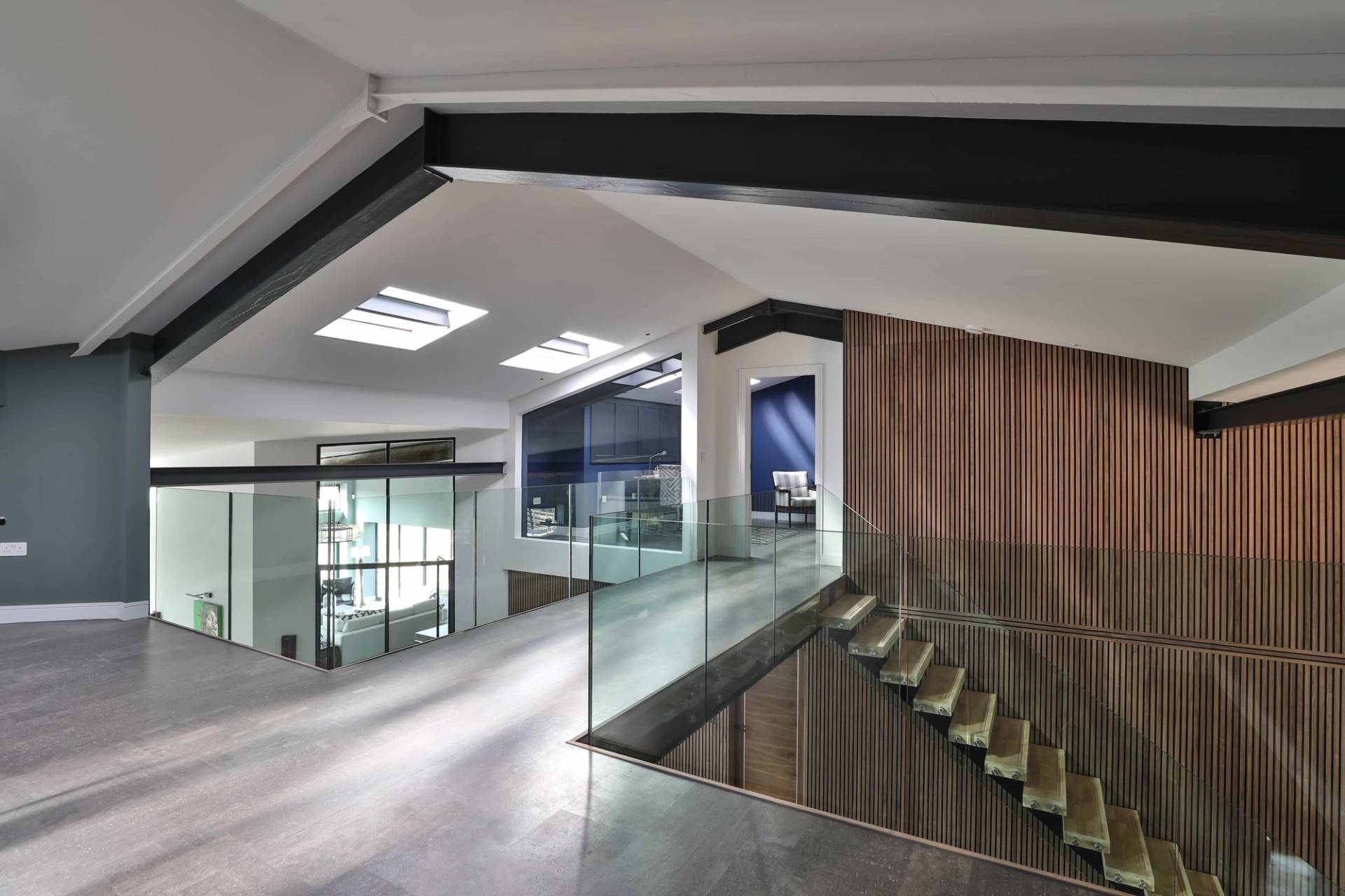 Upper mezzanine balcony looking over glass balustrades down to a double-height reception space, Love Locations CV23.