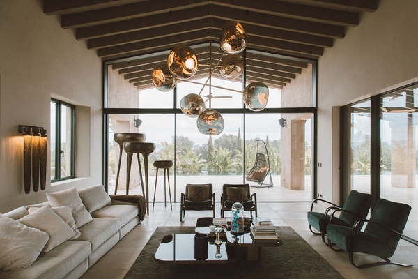 Double-height living room with glass windows framing views of the Mallorcan countryside, Love Locations 07630.