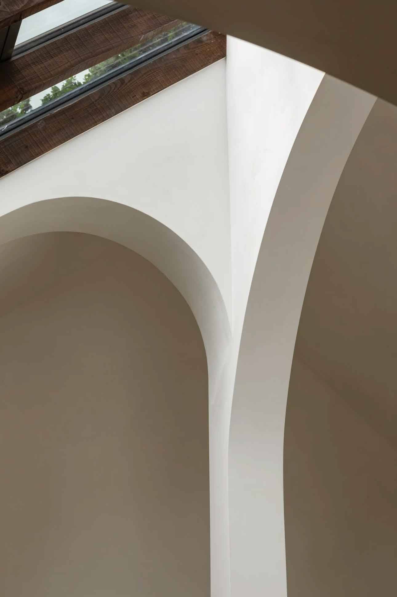 Architectural close-up of smooth curved plaster arches and vaulted ceiling detail in a modern Highgate location house, Love Locations.