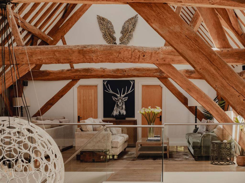 Upper-level mezzanine balcony lounge featuring a stag head artwork statement piece and exposed timber trusses, ideal for dramatic film scenes, Love Locations RG9.