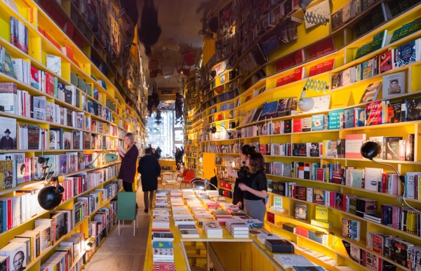 E1 Whitechapel bookshop with immersive shelving and warm lighting interior – love locations