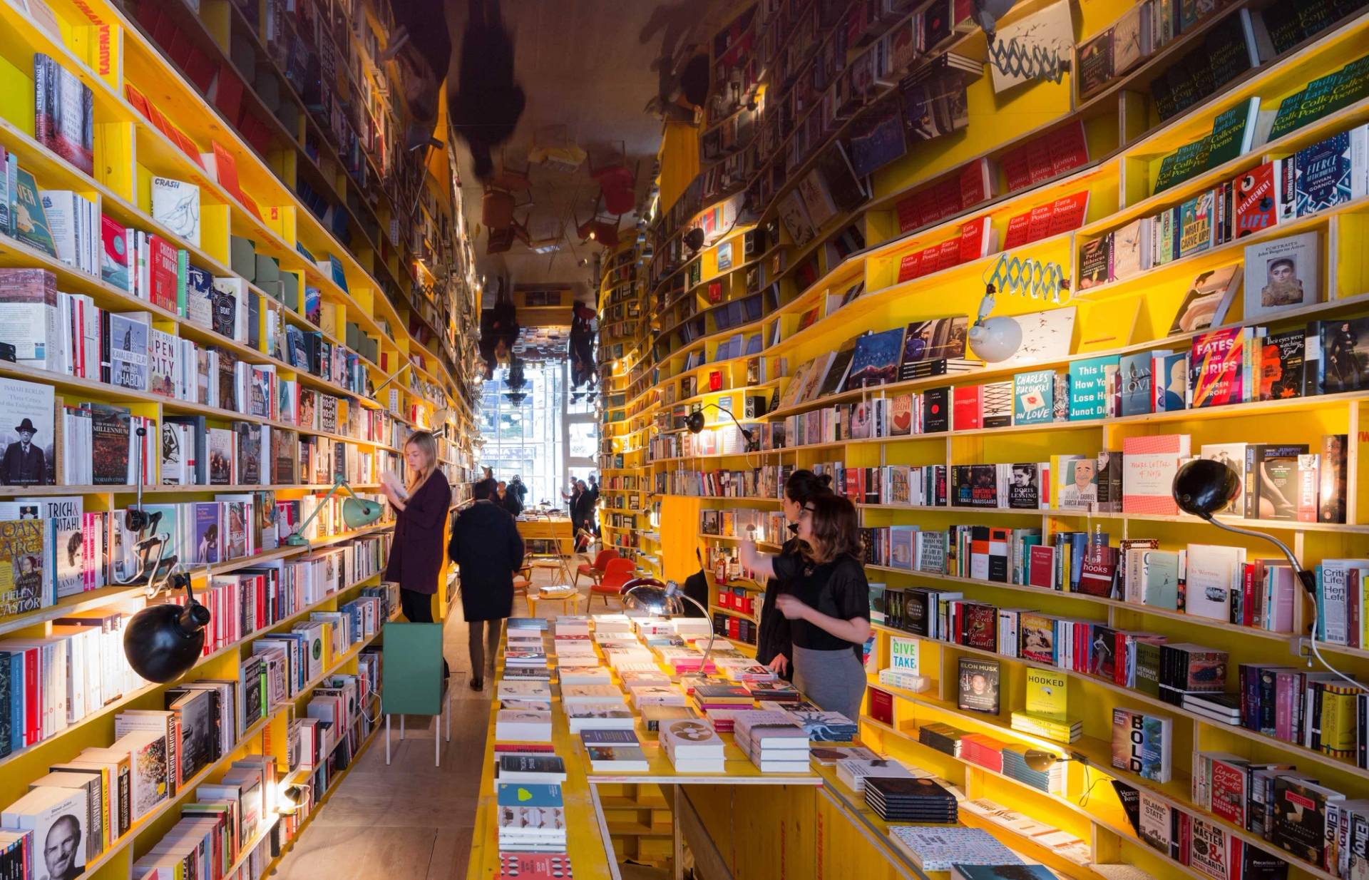 E1 Whitechapel bookshop with immersive shelving and warm lighting interior – love locations