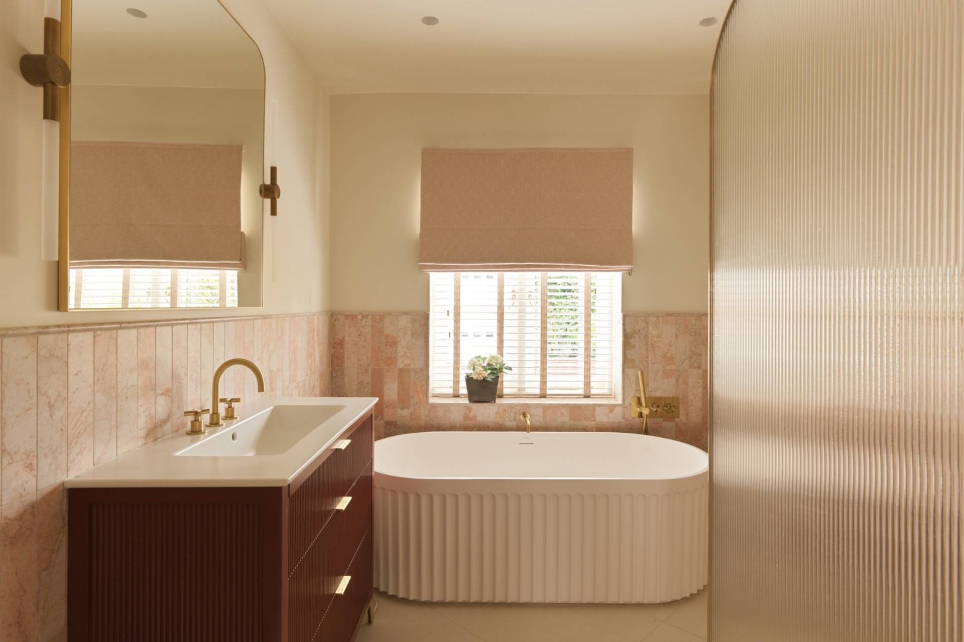 Luxury freestanding fluted bathtub in a microcement bathroom in Clapham South SW11 from Love Locations.