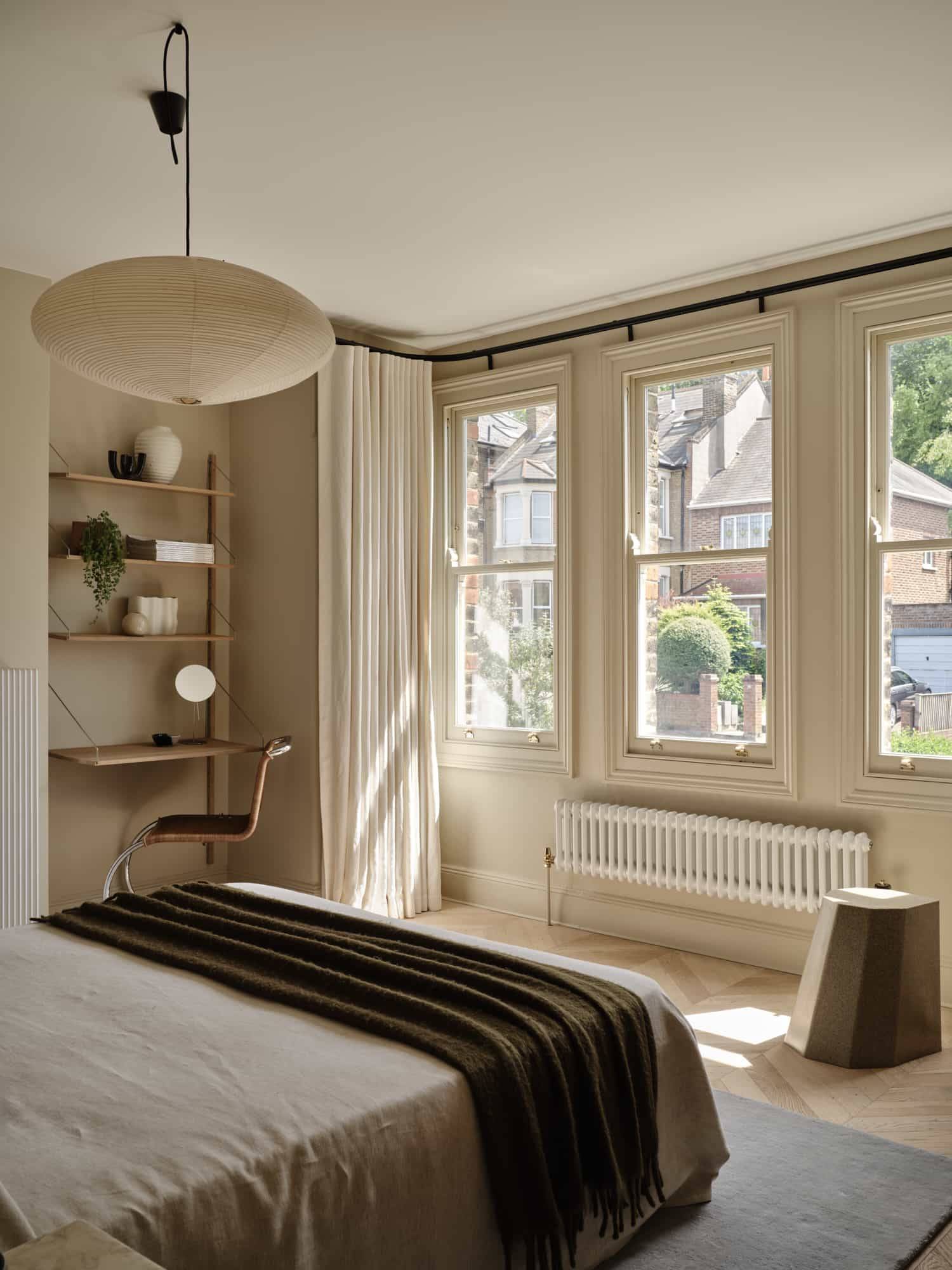Love Locations daylight bedroom location SE23: Spacious neutral bedroom layout framed by twin traditional Victorian sash windows overlooking the neighborhood, highly cinematic for TV.