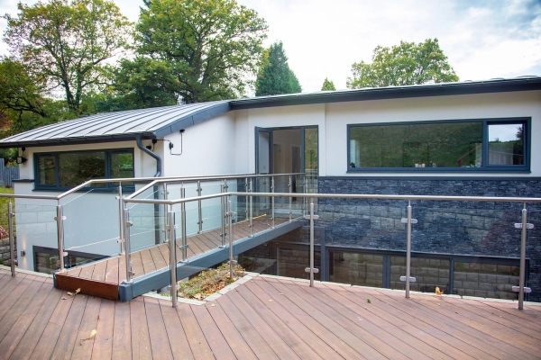 Architectural split-level timber decking terrace with a modern steel bridge structure on a contemporary Guildford house location, Love Locations.