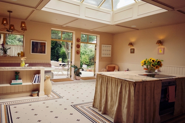 Sunlit conservatory kitchen extension with a large glass roof lantern and patterned floor tiles, great for morning lifestyle commercials, Love Locations West London.