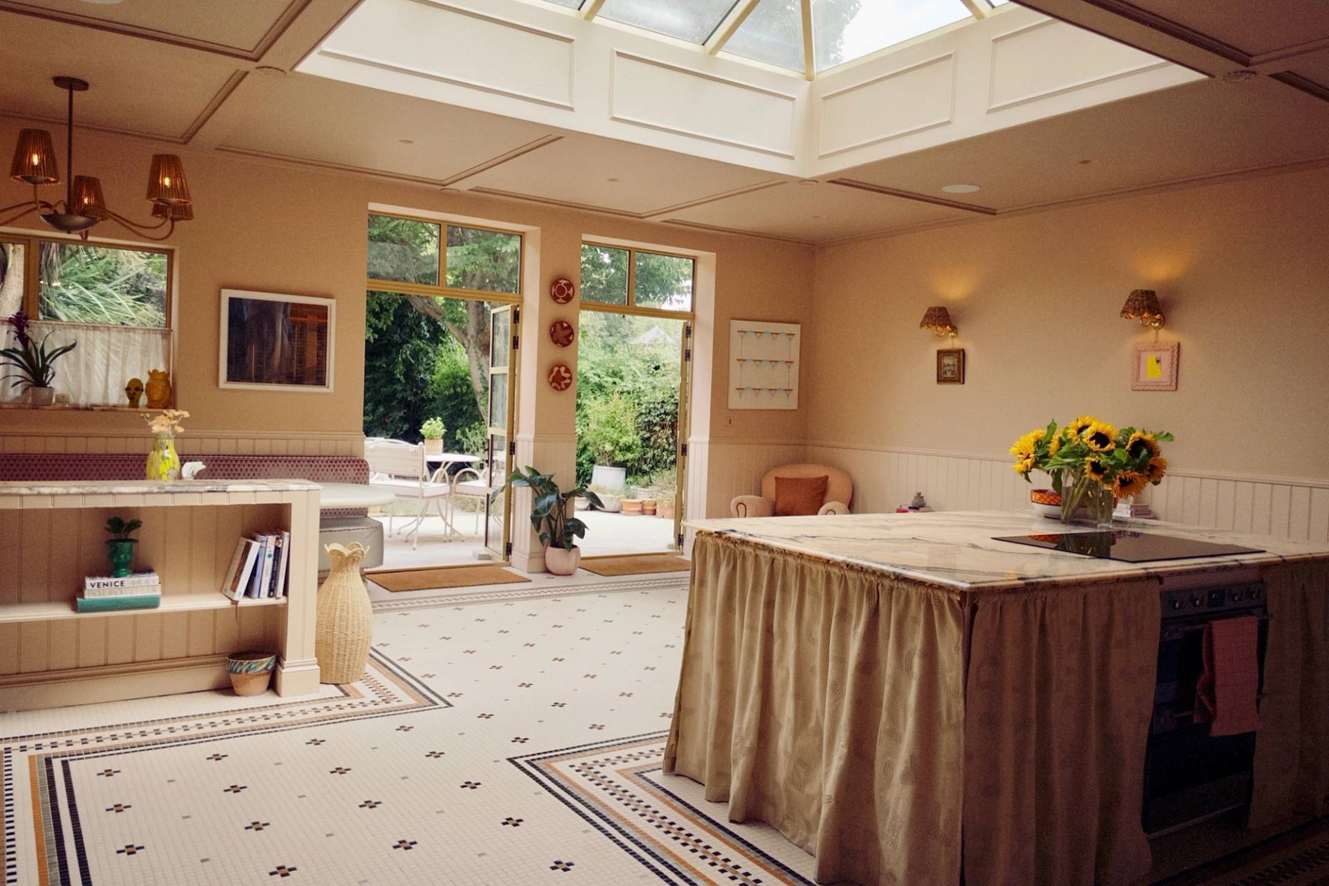 Sunlit conservatory kitchen extension with a large glass roof lantern and patterned floor tiles, great for morning lifestyle commercials, Love Locations West London.