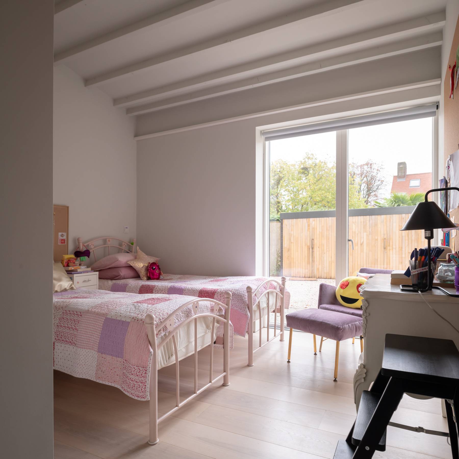 Kids bedroom suite featuring twin metal bed frames, pink textiles, and timber-beamed ceilings, Love Locations BN3.