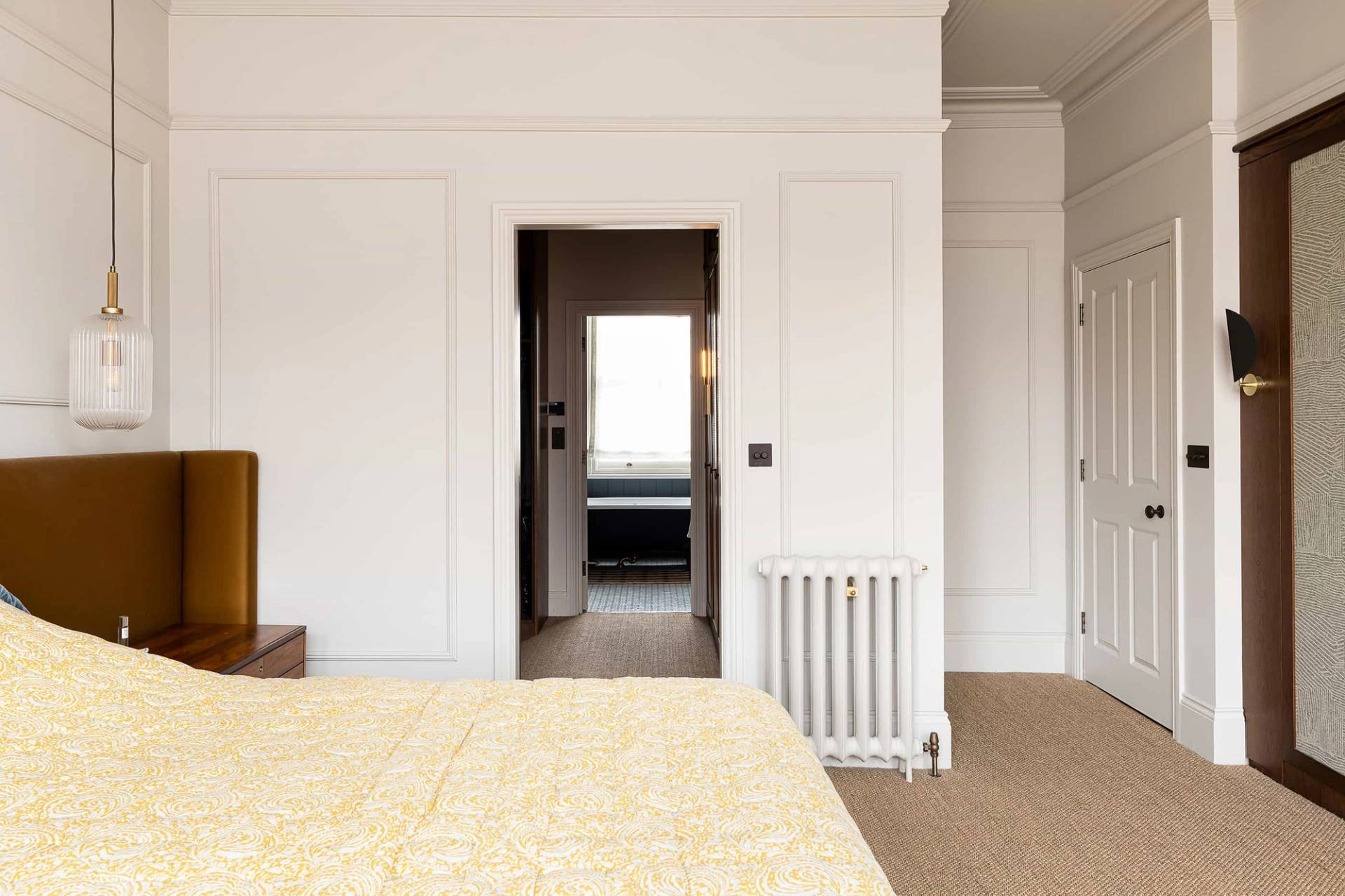 Master bedroom view looking into an adjoining ensuite bathroom through white panelled doors, Love Locations.