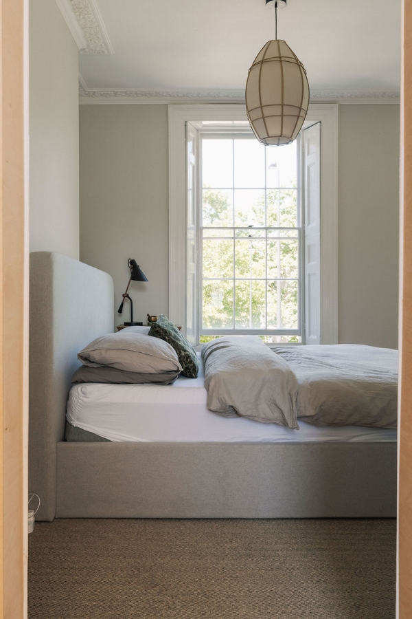 Chic master bedroom shoot location featuring neutral linens, a comfortable bed, and a tall sash window in Stockwell, SW9, Love Locations.