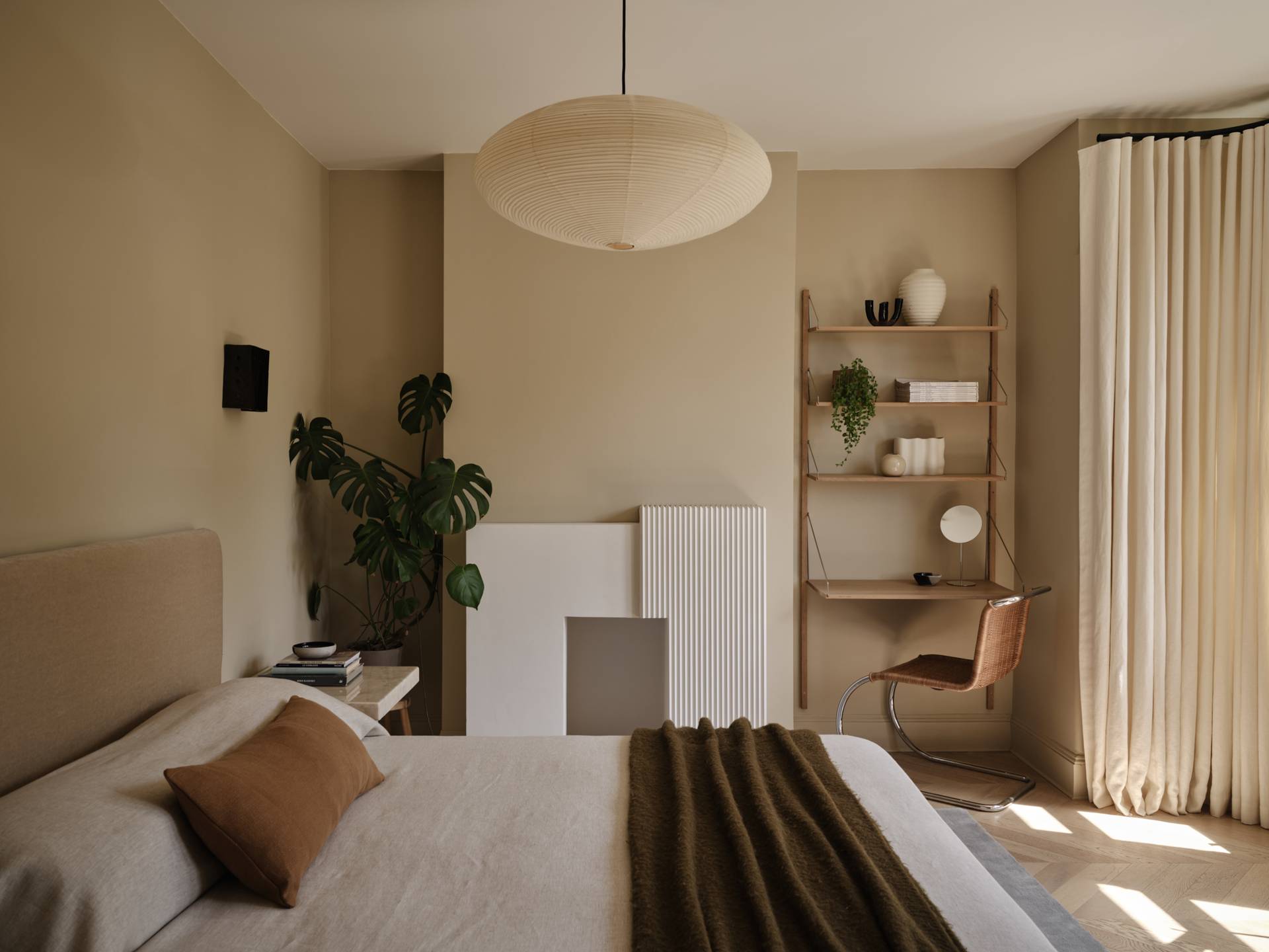 Love Locations minimalist bedroom shoot space SE23: Light-flooded master suite defined by soft neutral tones, linen textures, and an oversized paper pendant lamp, ideal for lifestyle campaigns.