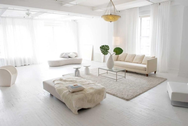 Bright minimalist open-plan studio loft shoot location in NYC, NY 10011 featuring all-white interior decor, large windows, and contemporary neutral furniture, ideal for high-end fashion lookbooks via Love Locations.