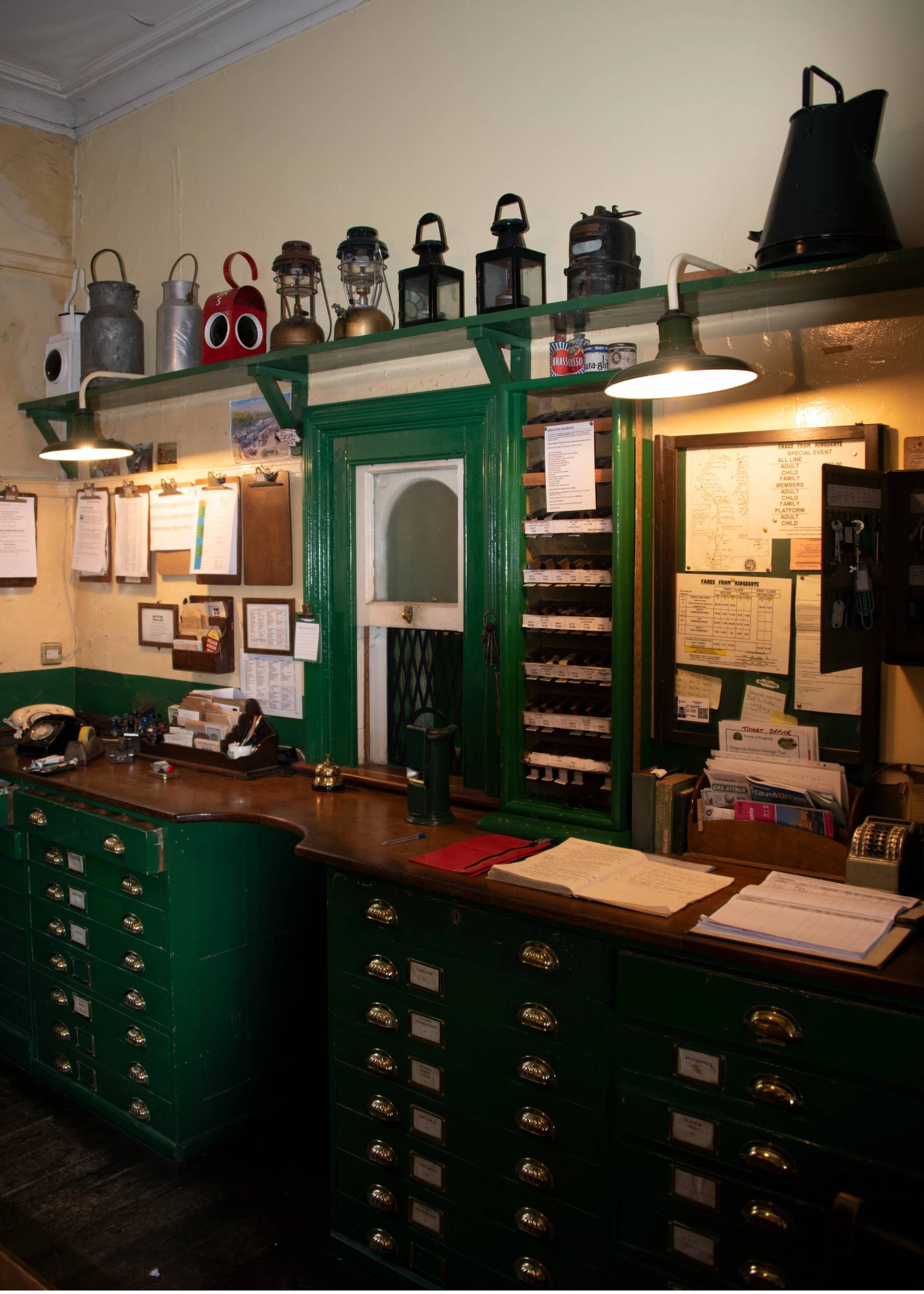 Vintage station master office featuring green timber desks, wall dials, and antique lamps, perfect for period drama sets, Love Locations.