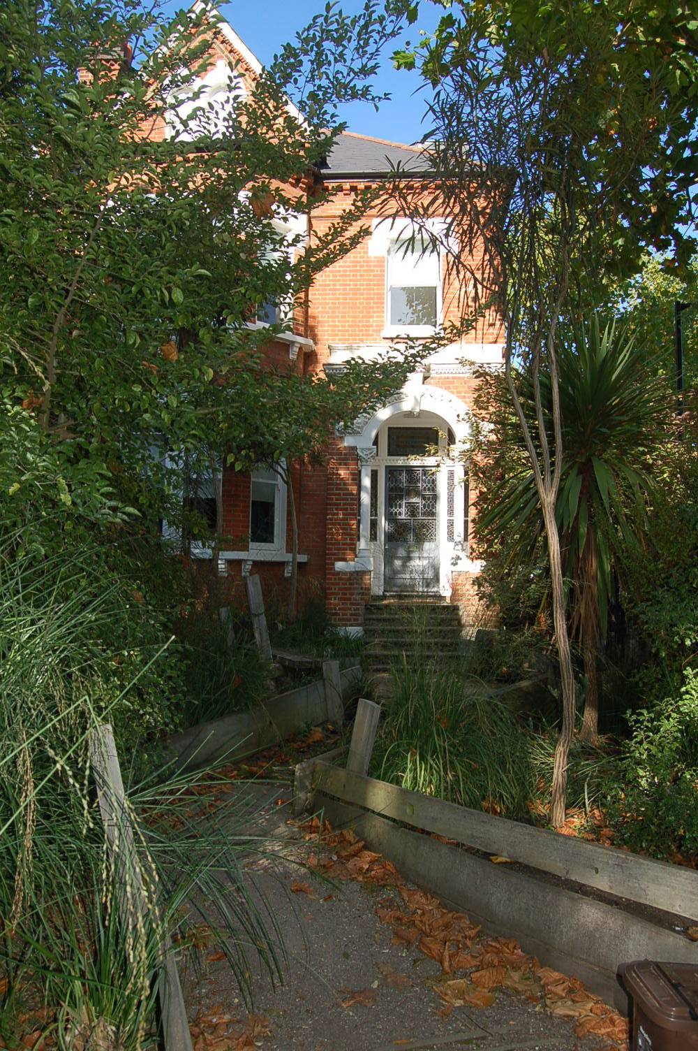 Victorian red brick villa shoot location hero cover image in South Camberwell / Denmark Hill, SE5 featuring a secluded garden walkway, dark green tiled bathroom, original tessellated tile hallway, and double reception room, the ultimate high-visibility backdrop for feature film productions, TV drama filming, brand campaigns, and editorial photography via Love Locations.