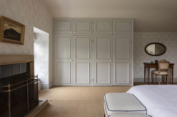 Glenstriven guest bedroom with elegant bed, neutral tones and window overlooking estate grounds