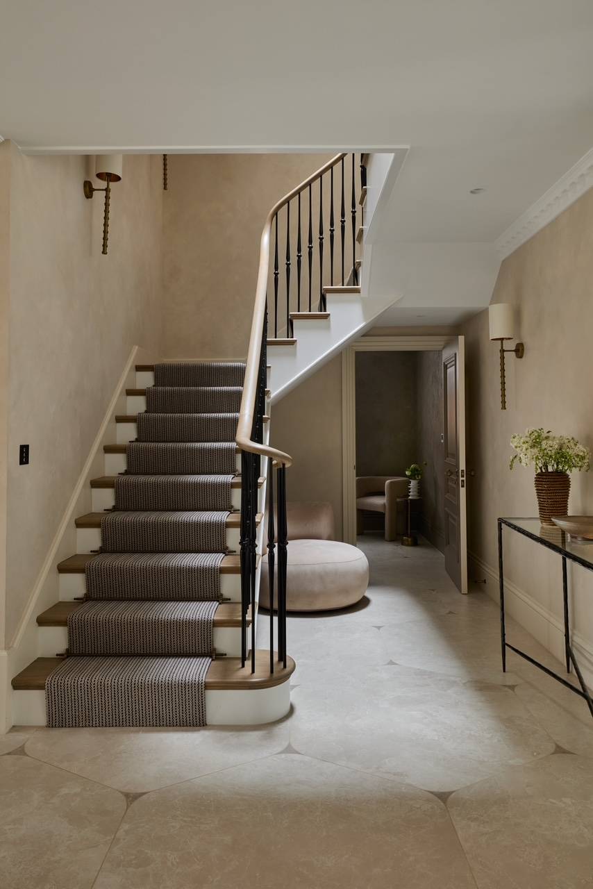 Sweeping stone staircase location in Hertfordshire, WD23 equipped with a classic grey striped carpet runner and slim iron balustrades, perfect for bridal fashion editorials, Love Locations.