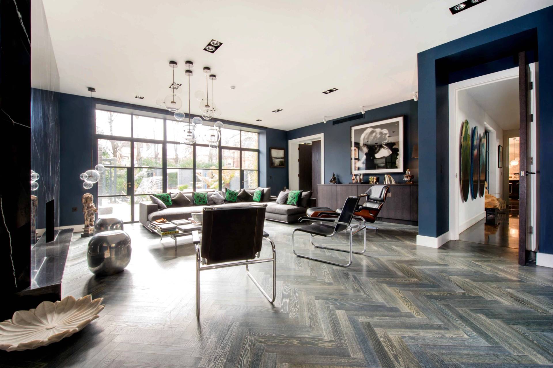 Contemporary living space view highlighting designer armchairs, coffee table styling, and a seamless connection to the outdoors, Love Locations NW3.
