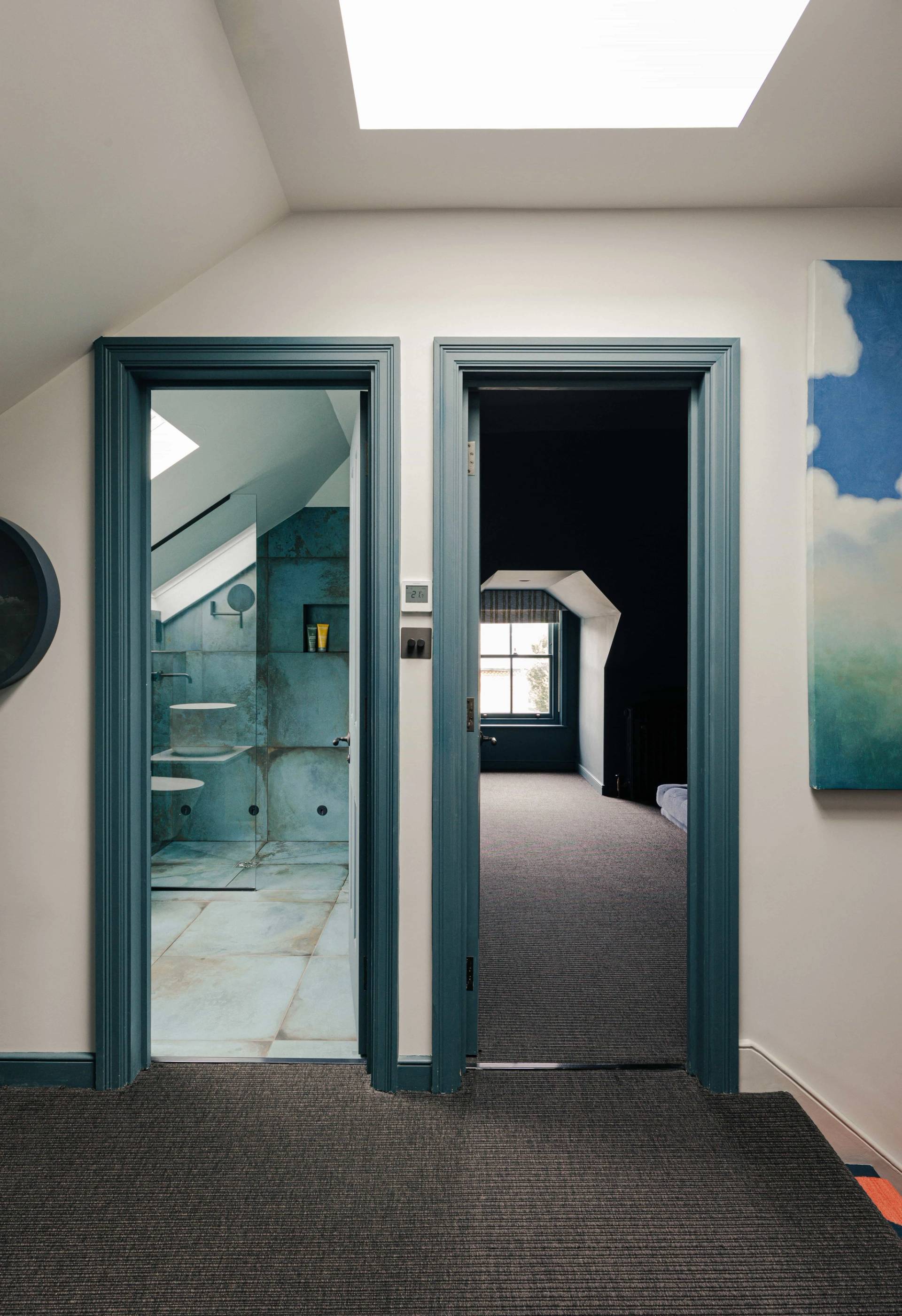 Dark teal doorway frame leading into a carpeted attic bedroom suite in Barnes, Love Locations SW13.