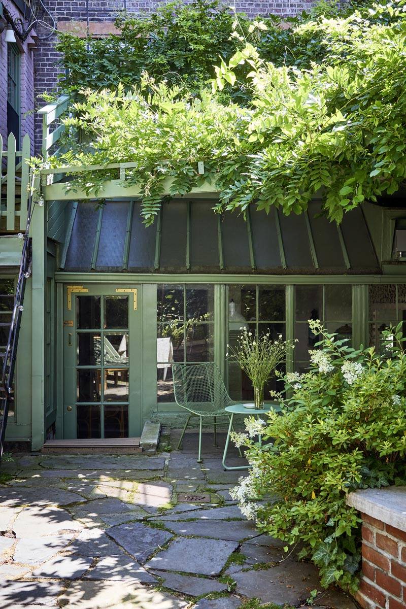 Private stone patio courtyard shoot location with green awning exterior and potted plants in Manhattan NY 10014 through Love Locations.