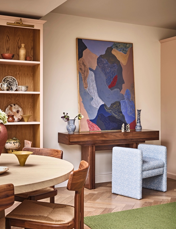 Modern reception room nook featuring a wooden console table, bold blue abstract painting, and light wood flooring, Love Locations SE21.