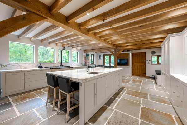 Open-plan kitchen with exposed timber beams in Essex barn, Love Locations