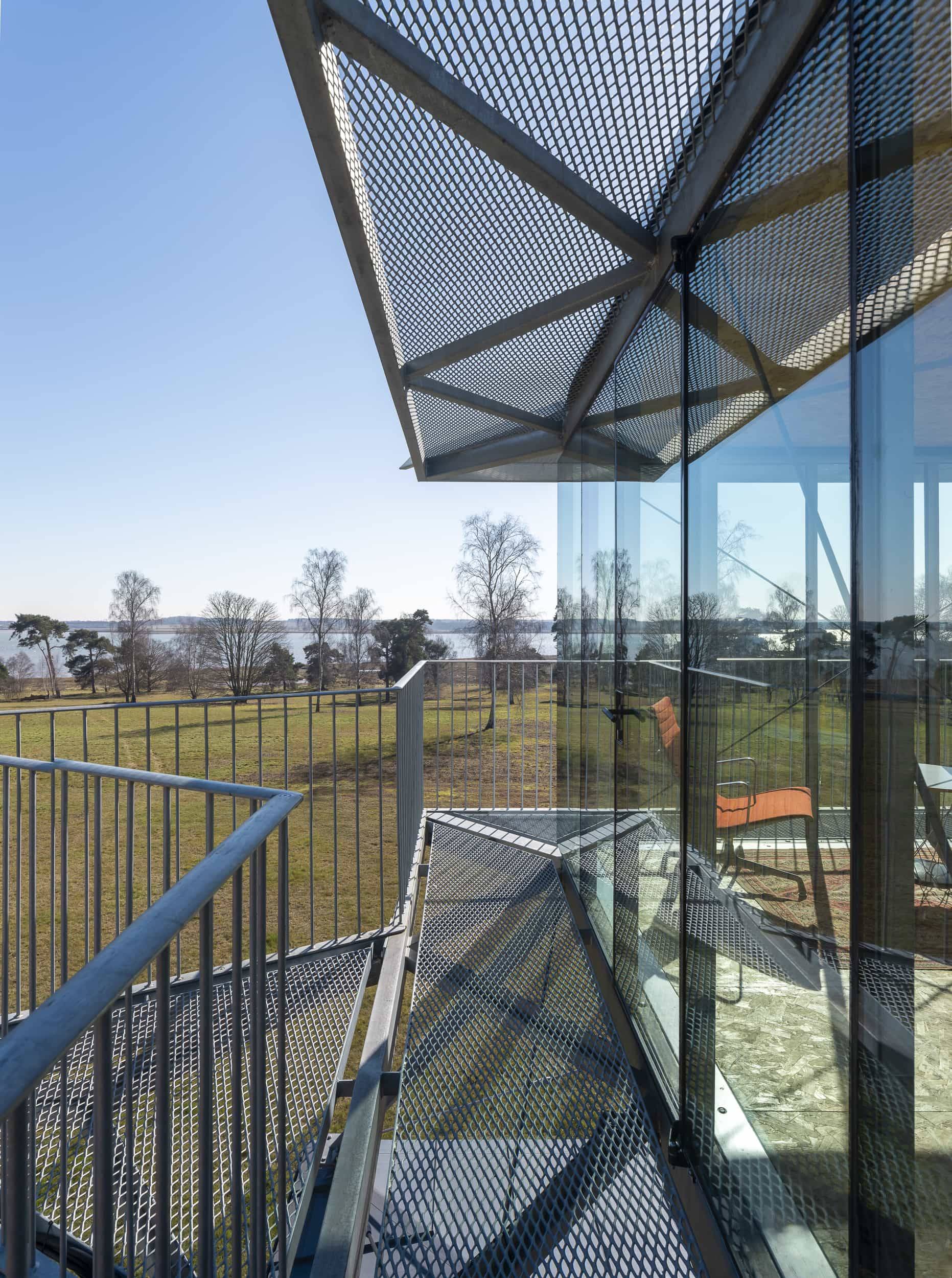 Exterior steel bridge walkway and glass balustrades on an elevated architectural studio tower, Love Locations IP17.