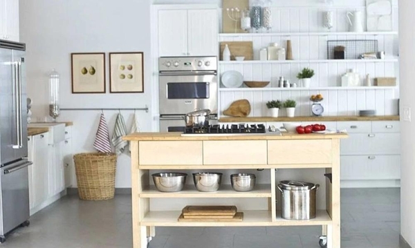 Modern mobile kitchen island with stainless steel appliances and open shelving inside a bright NYC studio, ideal for commercial cooking shows, Love Locations.