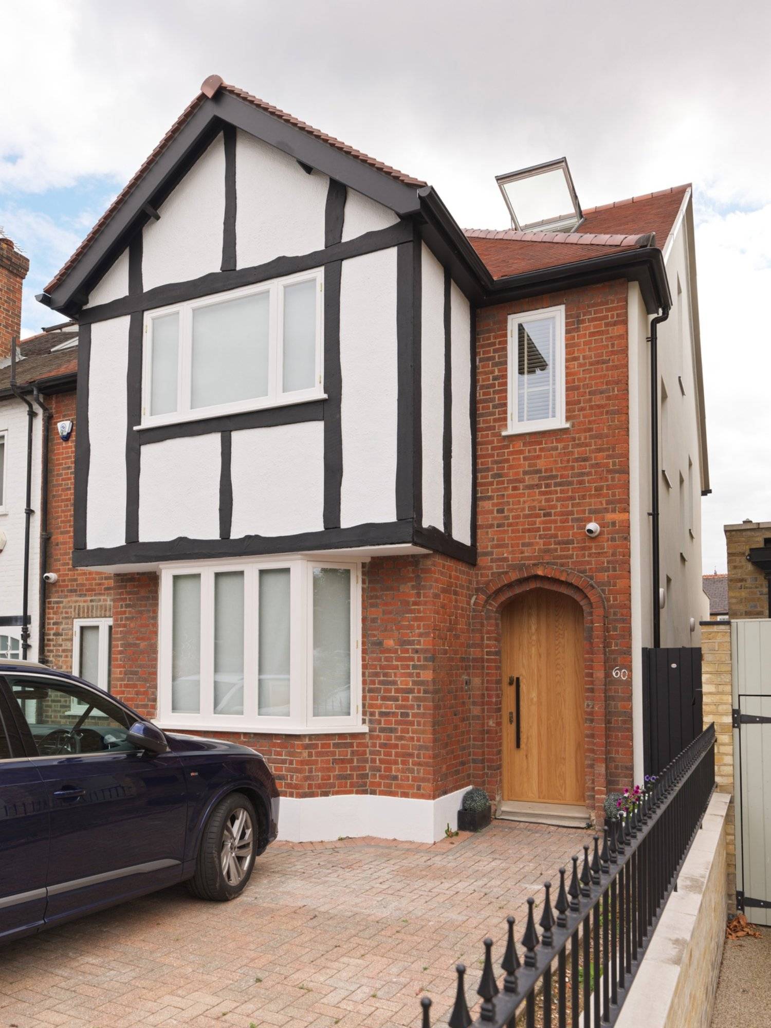 Front facade shoot location showing paved driveway parking and red-brick architectural details from Love Locations.