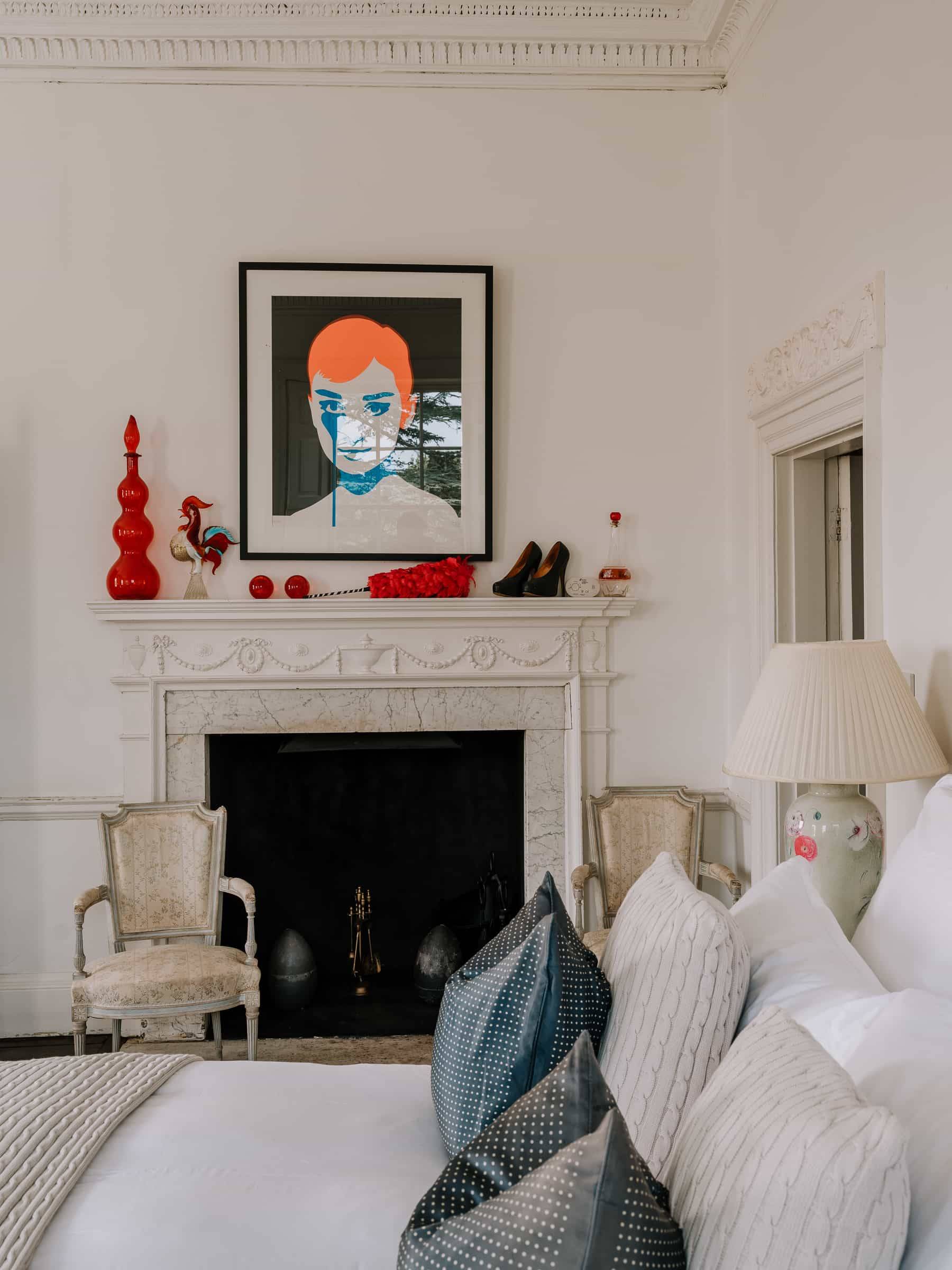 White fireplace mantle featuring pop-art portrait artwork and white decorative accessories, Love Locations RG42.