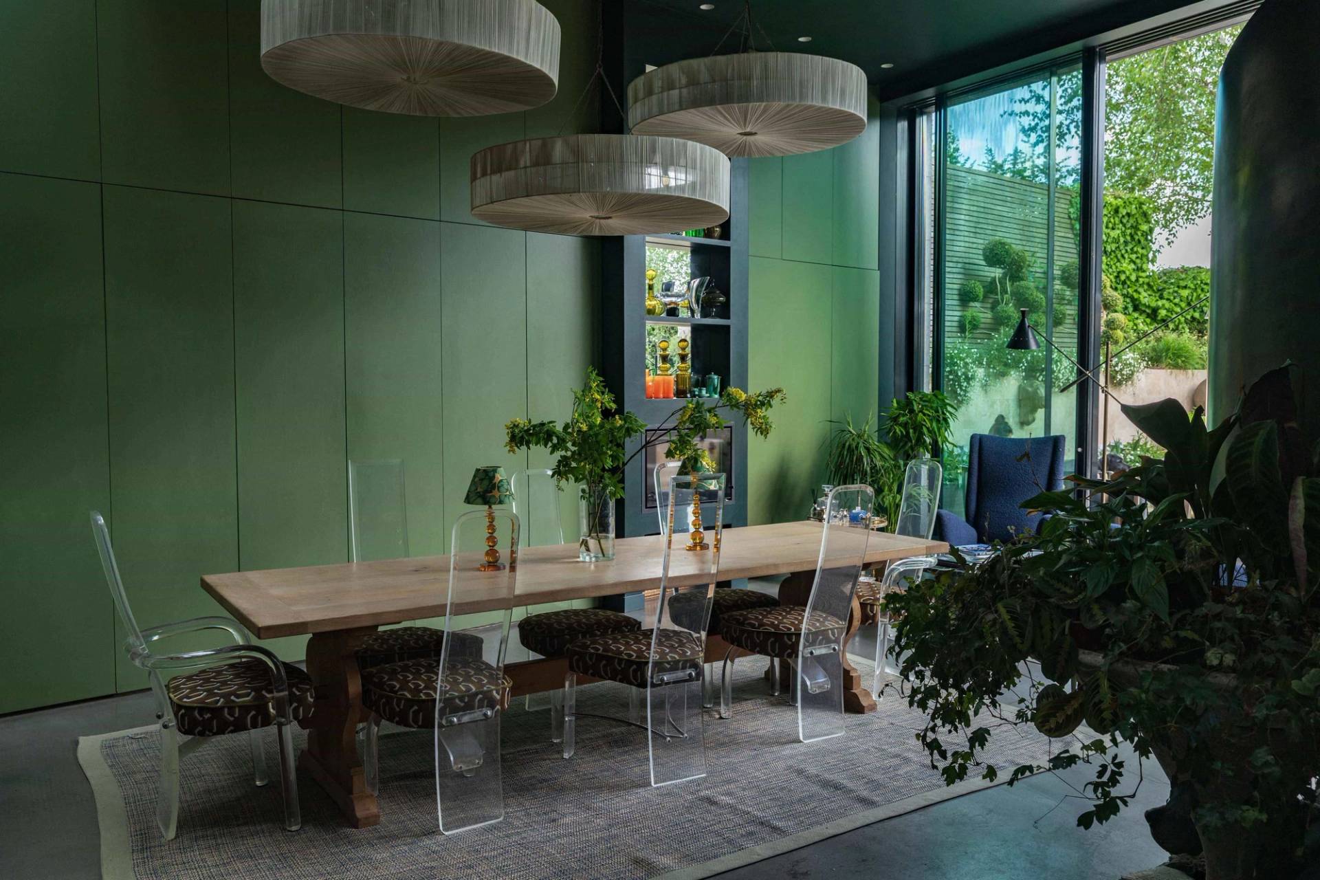 Spacious open-plan dining area with clear acrylic chairs, long timber dining table, and floor-to-ceiling glass patio doors in Wimbledon, SW20, ideal for homeware lookbooks, Love Locations.