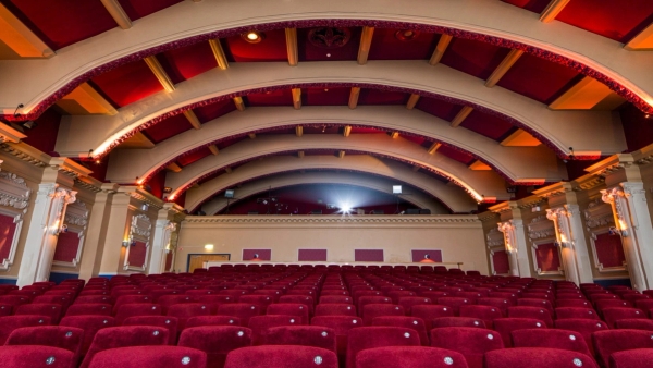Direct rear view showing rows of red velvet cinema seats facing the projection booth at The Ritzy Screen 1 shoot location in Brixton SW2 by Love Locations.