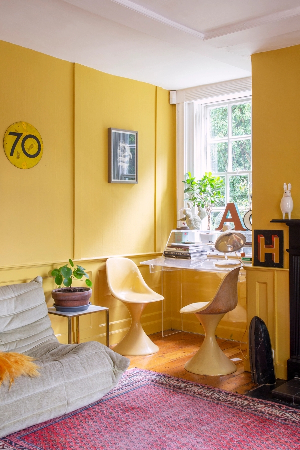 Yellow panelled room nook with orange retro chairs, small wooden desk, and sash window light, Love Locations ME13.