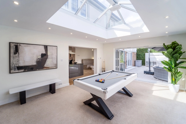 White slate pool table in an open-plan glass roof extension with bi-fold doors, Love Locations RM11.