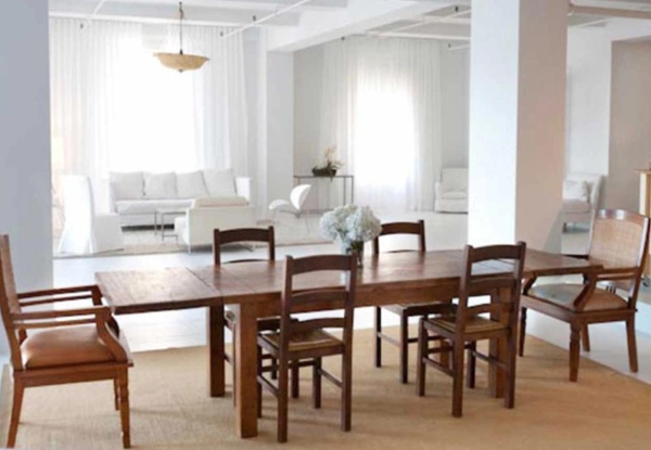 Large rustic wooden dining table and chairs set inside a bright loft studio space, perfect for family dining commercials and editorial content, Love Locations NYC.