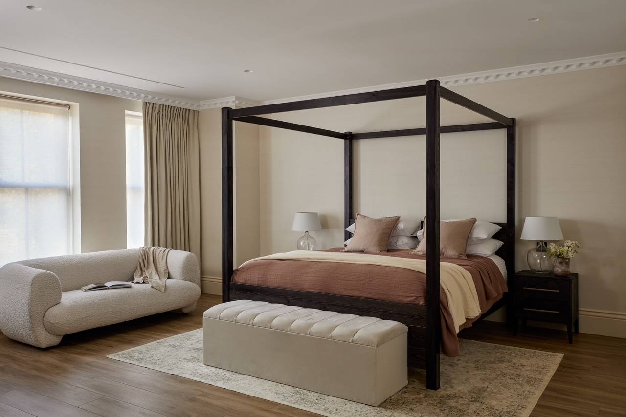 Luxury bedroom set in Hertfordshire, WD23 showcasing a dark wood four-poster bed frame and soft neutral accents, perfect for upscale furniture catalogs, Love Locations.