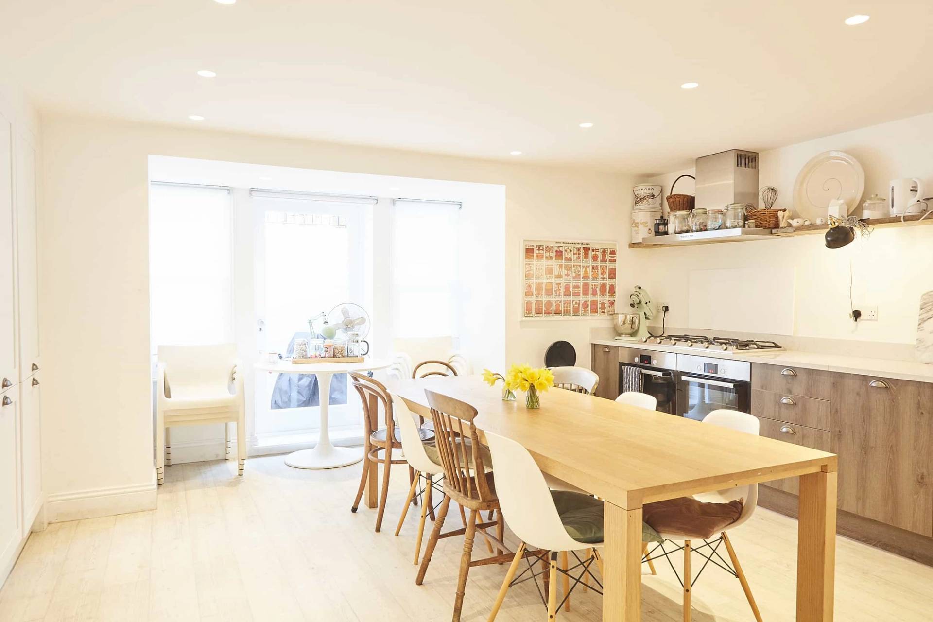 Formal dining room location featuring a long solid oak dining table, wooden chairs, and overhead pendant lighting, ideal for family brand ads, Love Locations.